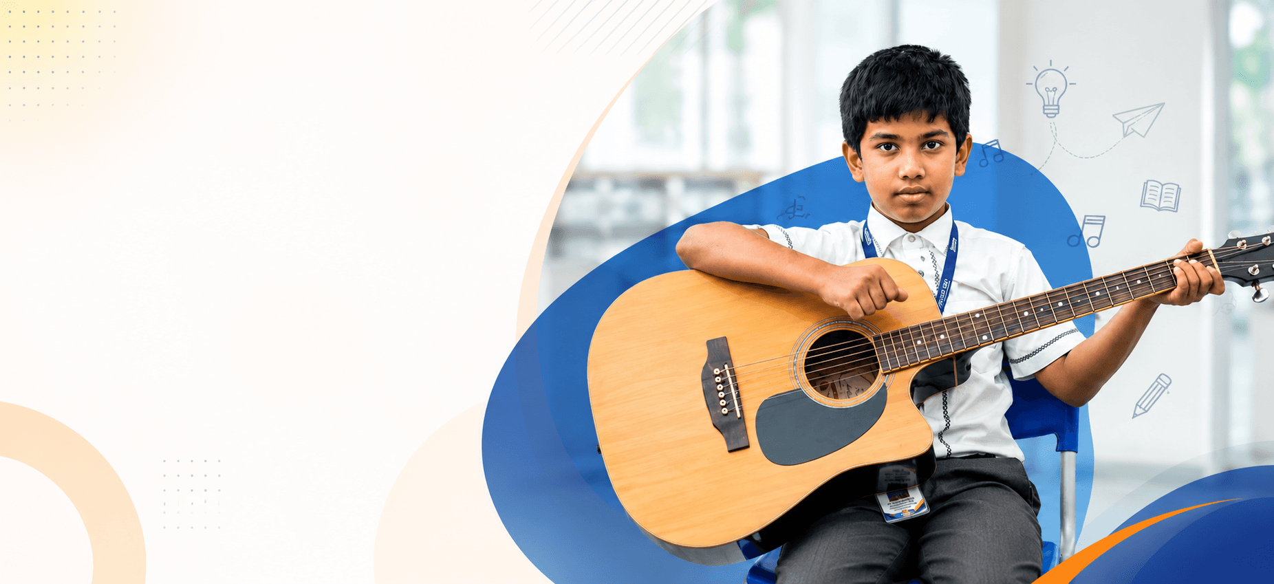 Student playing acoustic guitar in music class